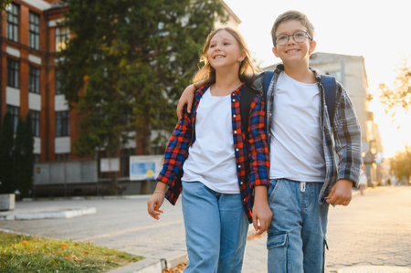 Happy children near the school. Friends boy and girl together in the school yard.の写真素材