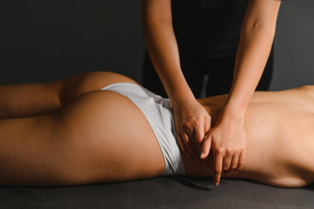 Spa woman. Female enjoying relaxing back massage in cosmetology spa centre.の写真素材