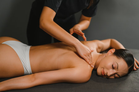 Beautiful woman having relaxing in spa massage salon.の写真素材