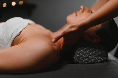 Masseur doing massage on woman body in the spa salon. Beauty treatment concept.の写真素材