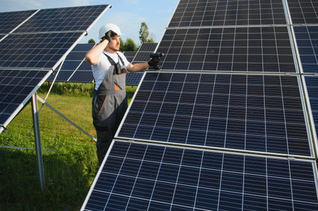 Worker installing solar panels outdoors.