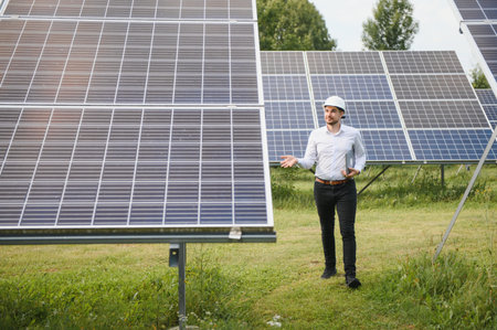 The solar farm, solar panel with engineer check the operation of the system, Alternative energy to conserve the world's energy, Photovoltaic module idea for clean energy production.の写真素材