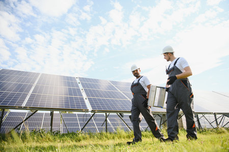Two workers installing solar panels.