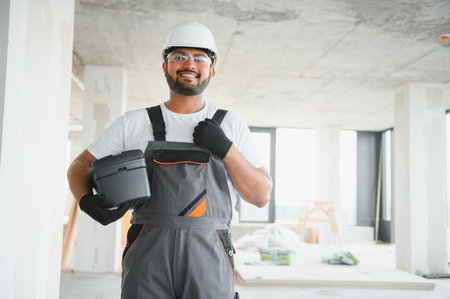 moving, repair and people concept - happy smiling Indian worker.の写真素材