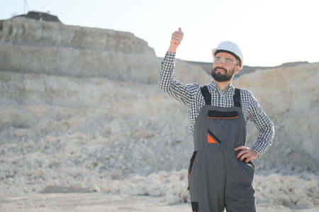 Extraction of stone. Male worker next to stone quarry. Engineer at construction site.の写真素材