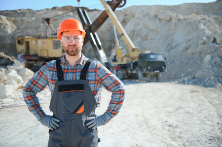 Portrait of a worker standing on the background of a stone quarry.の写真素材