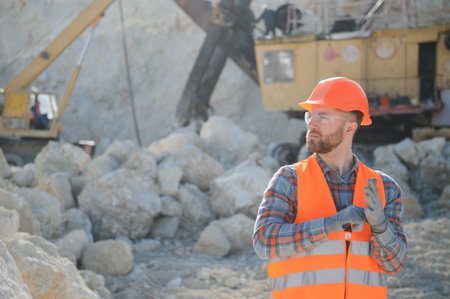 Male worker with bulldozer in sand quarry.の写真素材