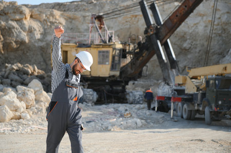 Worker and quarry in background.