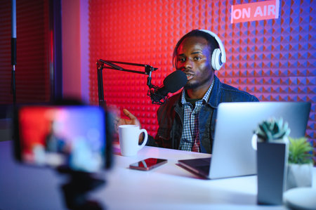 Cheerful young African American male blogger.の写真素材