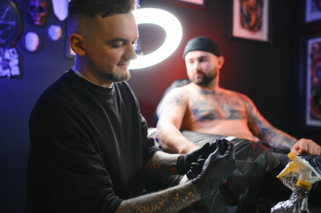 Professional tattoo artist makes a tattoo.の写真素材