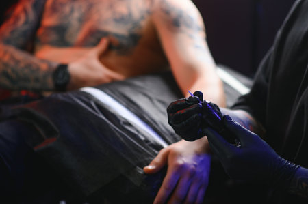 Professional tattoo artist makes a tattoo.の写真素材