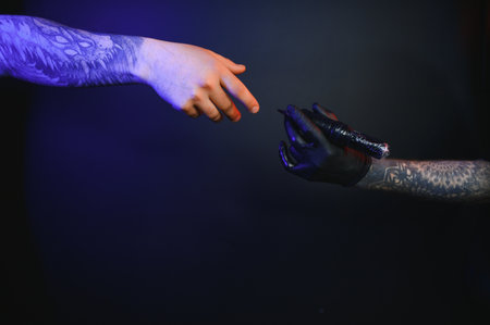 Close up cropped photo of tattooer master artist male hold in hand machine black ink in jar, equipment for making tattoo art on bodyの写真素材