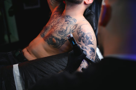 Professional tattoo artist makes a tattoo.の写真素材