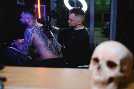 Professional tattoo artist makes a tattoo.の写真素材