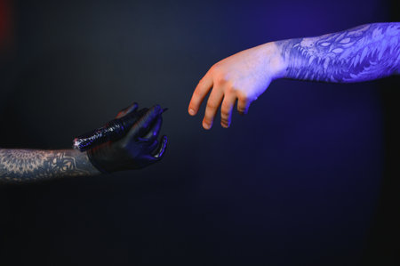 Close up cropped photo of tattooer master artist male hold in hand machine black ink in jar, equipment for making tattoo art on bodyの写真素材