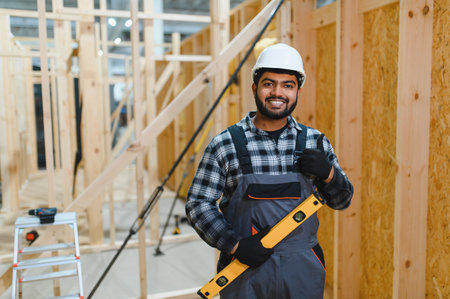 Indian carpenter works on the construction of modular houses.の写真素材