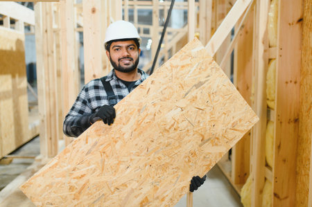 Indian carpenter works on the construction of modular houses.