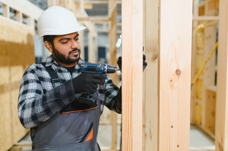 Indian carpenter works on the construction of modular houses.の写真素材