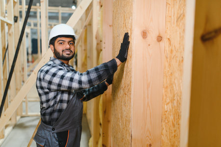 Indian carpenter works on the construction of modular houses.