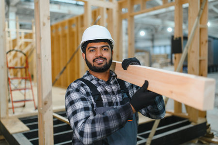 Indian carpenter works on the construction of modular houses.の写真素材