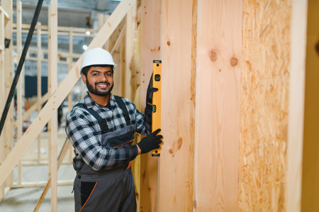 Construction of modular houses. Indian construction worker or engineer at construction site.の写真素材