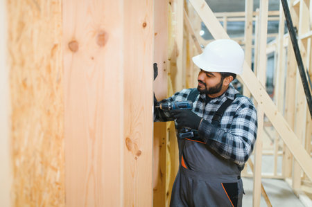 Indian carpenter works on the construction of modular houses.の写真素材