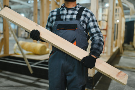 Indian carpenter works on the construction of modular houses.の写真素材