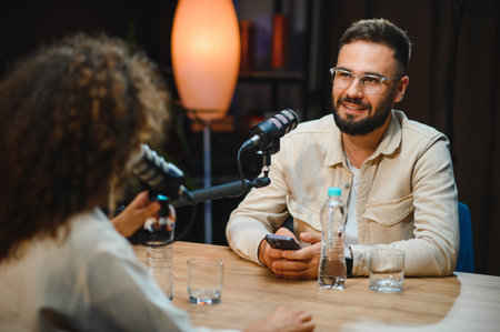 Two content creators recording a podcast episode in a professional studio, engaging in conversation...