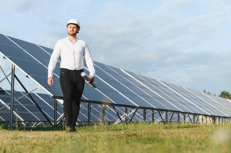 Engineer walking among rows of solar panels, holding blueprints, representing renewable energy and...