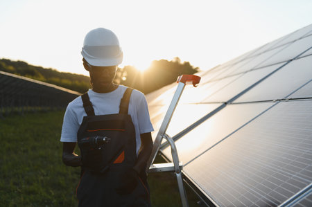Young man installing solar panels, contributing to renewable energy production and sustainable...