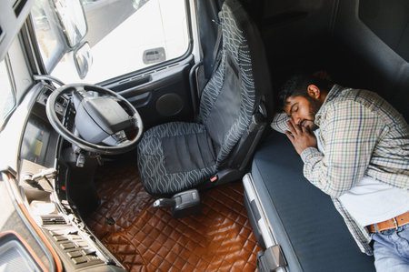 Truck driver sleeping in the cab, taking a break from a long journey on road, prioritizing safety...
