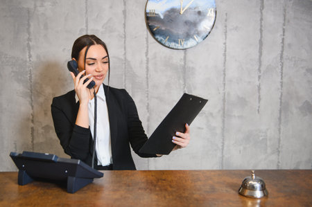 Professional hotel receptionist providing customer service, managing inquiries and bookings. Delivering hospitality and supportの写真素材
