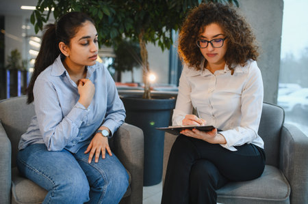 Female psychologist providing support and guidance to a young Indian woman seeking professional help for mental well beingの写真素材