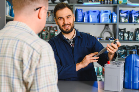 Auto service worker explaining auto parts to a client, offering consultation and professional advice...