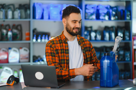 Salesman using barcode scanner on a blue lubricant container at an automotive parts retail shop,...