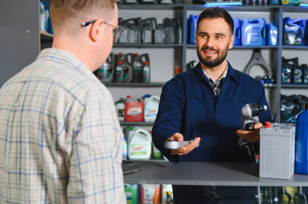 Mechanic providing excellent customer service in an auto shop, recommending suitable automotive components and vehicle batteryの写真素材