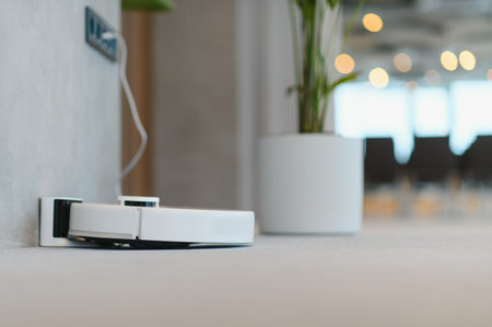 Smart robot vacuum cleaner on its charging station, providing efficient automated housekeeping and...