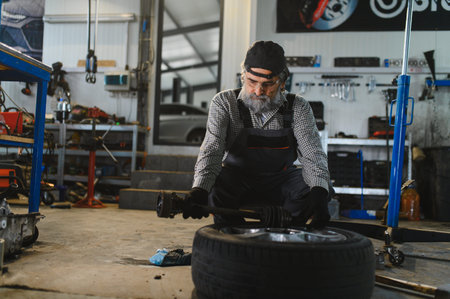 Experienced mechanic working on a car component, providing professional repair and maintenance service in an automotive workshop