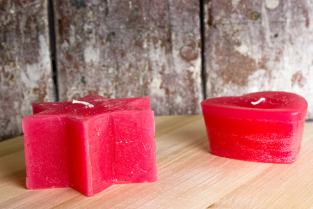 Two red candles on the wooden tableの写真素材