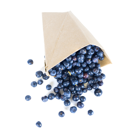 ripe blueberries scattered from a package isolatedの写真素材
