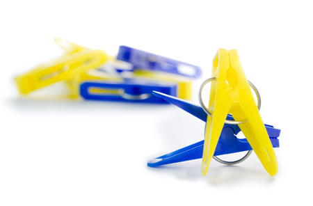 blue and yellow pegs isolatedの写真素材