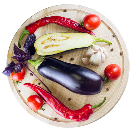 group of red ripe tomatoes and parsley on a wooden boardの写真素材