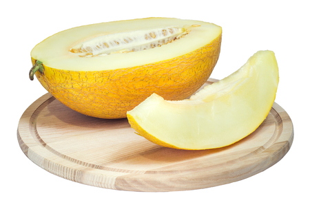 Slices of ripe yellow melon on a wooden surfaceの写真素材