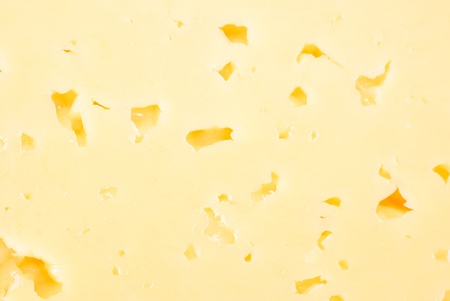 Background of fresh yellow cheese with holes の写真素材