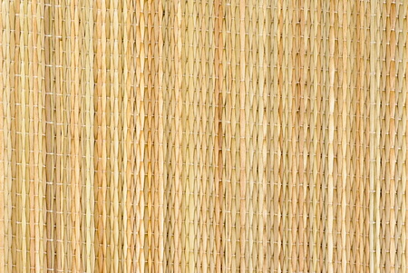 Background from dry straw tied up by threads 