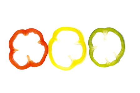 red, green and  yellow sliced pepper isolated on white background の写真素材