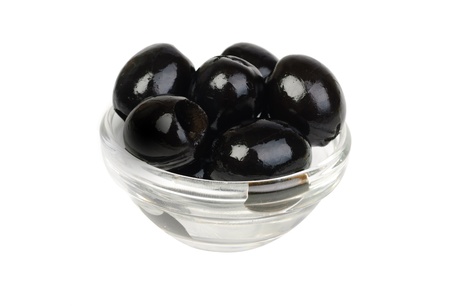 Black pitted olives in glass isolated on white macro の写真素材