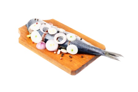 herring on wooden hardboard isolated on white background の写真素材