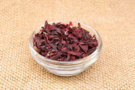 Hibiscus tea macro dry flower on sackcloth backgroundの写真素材