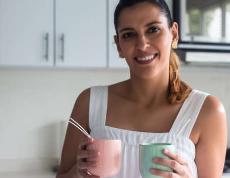 Latina woman showing two homemade candles